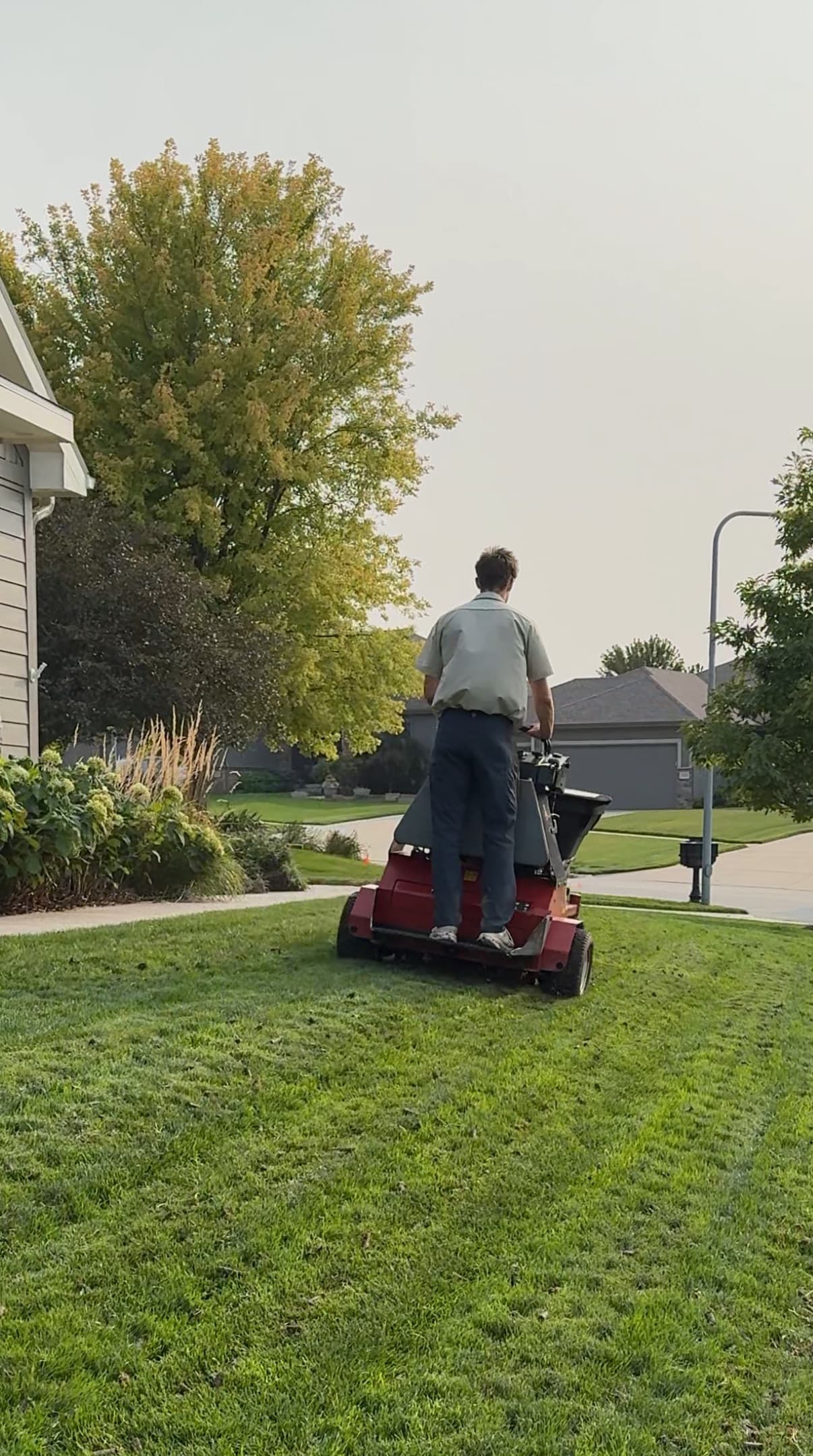 Aerator working down a lawn in the Omaha metro